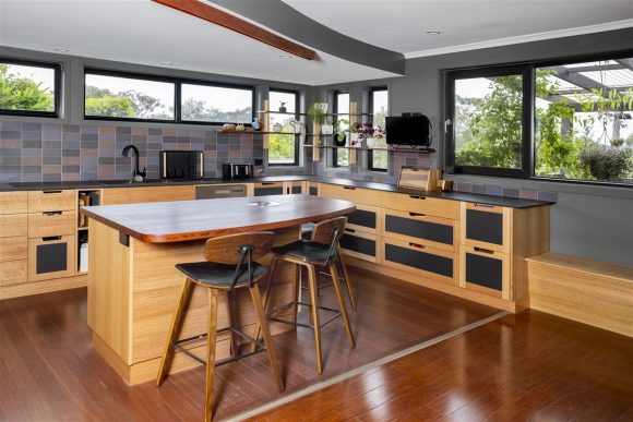 Solid plywood with Tasmanian Oak kitchen and matte black glass doors.